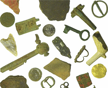 different archaeological objects including coin, arrowhead, key, pottery