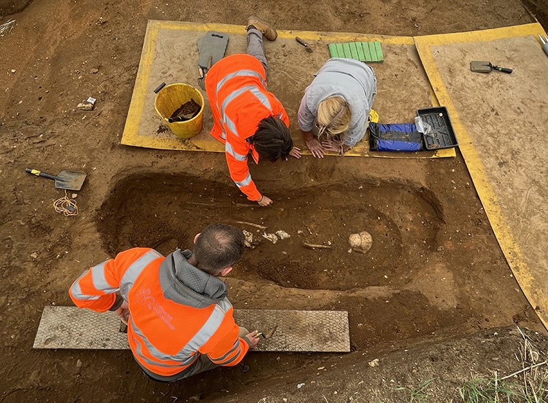 people excavating burial