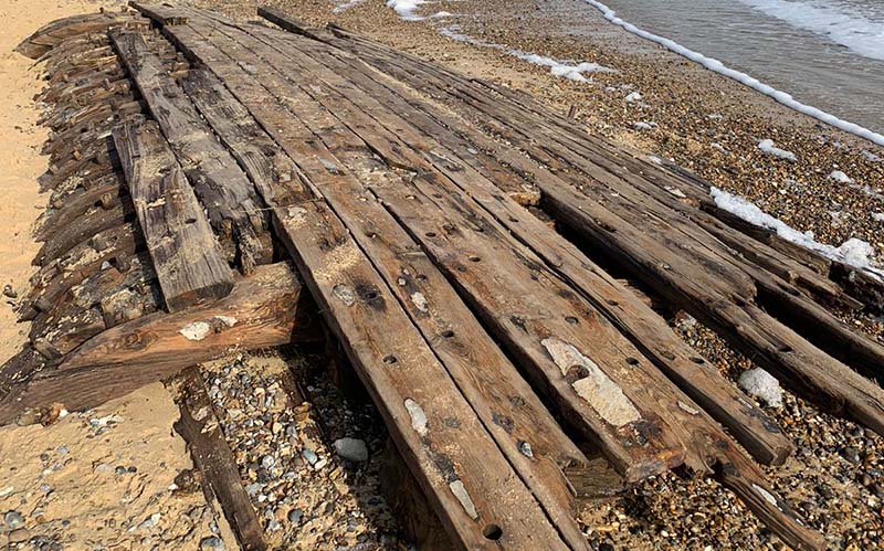 wooden planks on sandy beach