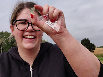 person holding archaeological object